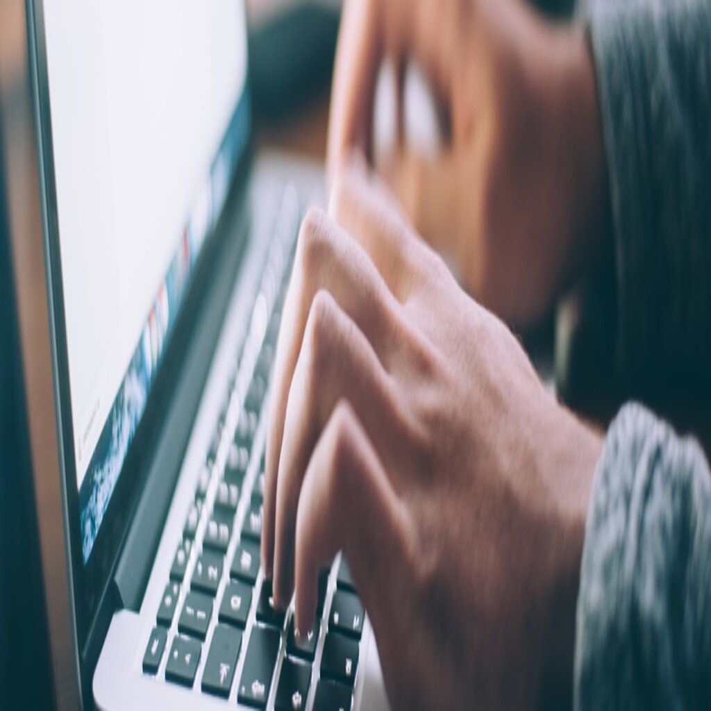 two hands on computer keyboard