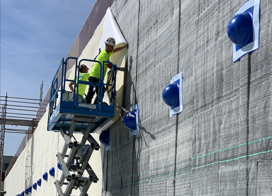 Two Men Waterproofing Wall