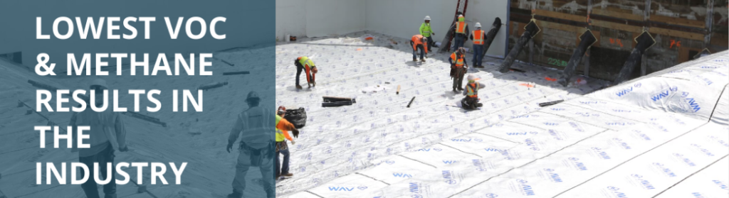 Men helping lay down AVM material